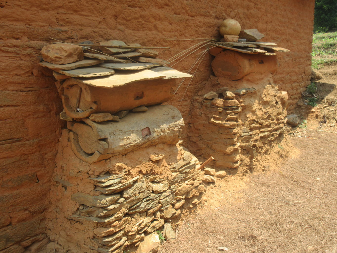 Traditional beehives outside a house